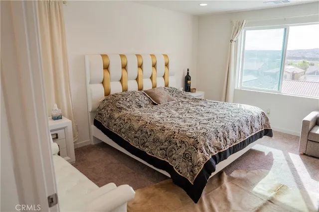 a bedroom with a bed and window