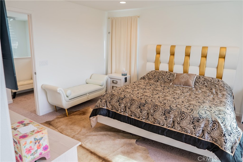 35227 Vernon Drive Beaumont, CA 92223 - Photo 26 of 49 a bed sitting in a bedroom next to a window with wooden floor