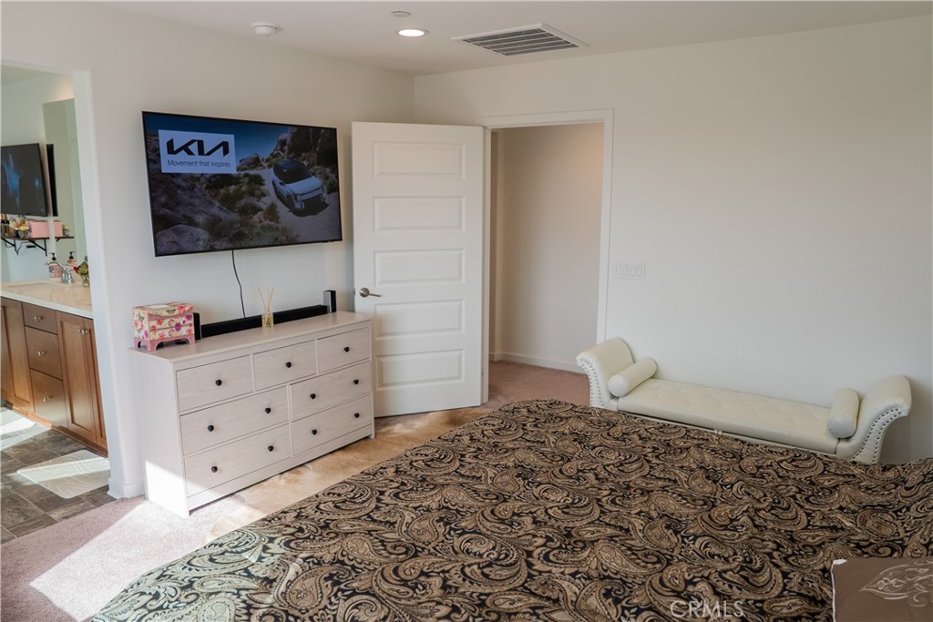 35227 Vernon Drive Beaumont, CA 92223 - Photo 28 of 49 a bedroom with a bed and a flat screen tv