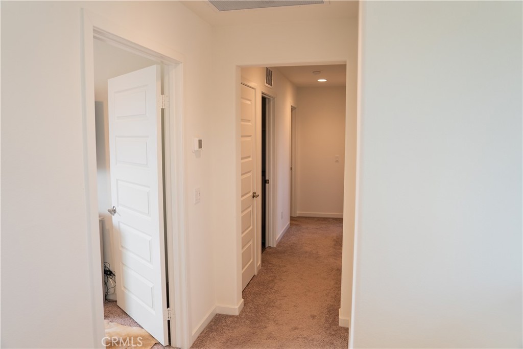 35227 Vernon Drive Beaumont, CA 92223 - Photo 32 of 49 a view of a hallway with wooden floor