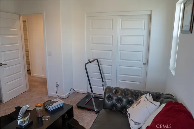 a bed room with a bed and a chair