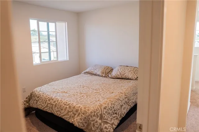 a bed sitting in a bedroom next to a window