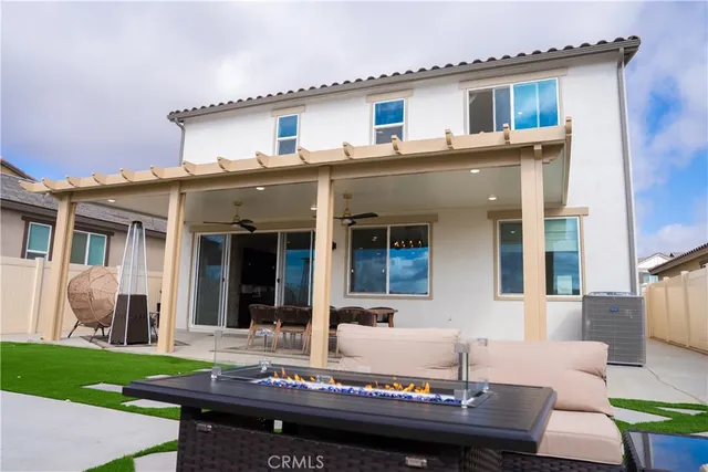 a view of a house with a patio and a yard