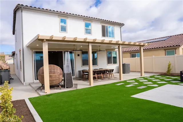 a view of a house with patio and a yard