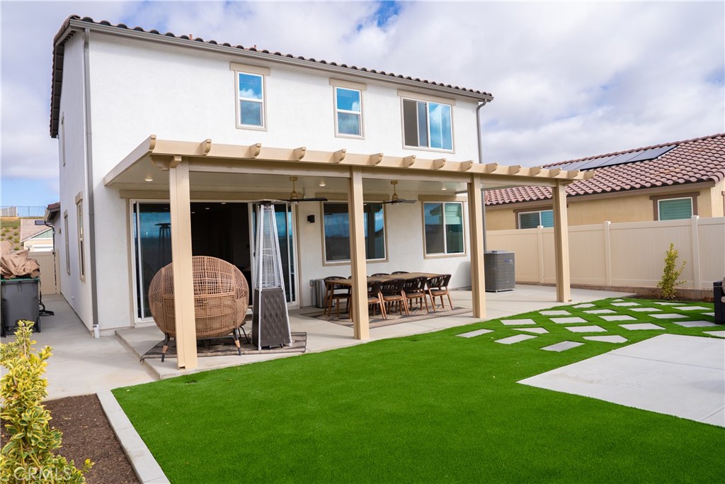 35227 Vernon Drive Beaumont, CA 92223 - Photo 40 of 49 a view of a house with patio and a yard