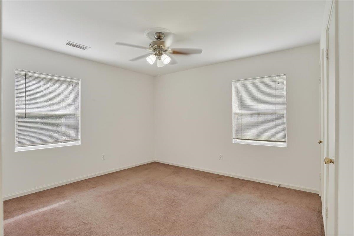 4850 Marcel Avenue Memphis, TN 38122 - Photo 16 of 20 Carpeted primary room featuring ceiling fan and baseboards, and half bath