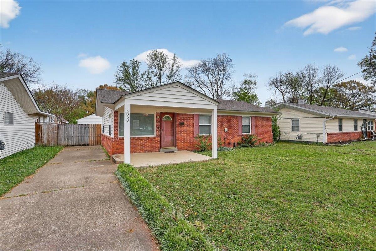 4850 Marcel Avenue Memphis, TN 38122 - Photo 2 of 20 View of front of home with brick siding, driveway, and a porch