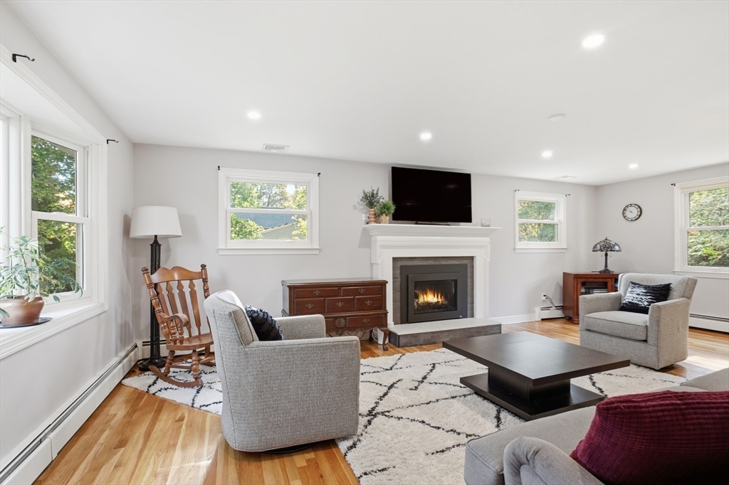 5 Carnegie Place Lexington, MA 02420 - Photo 13 of 39 a living room with furniture a fireplace and a flat screen tv