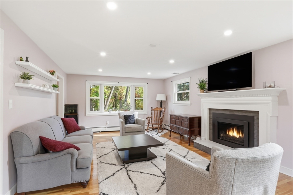 5 Carnegie Place Lexington, MA 02420 - Photo 14 of 39 a living room with furniture a fireplace and a flat screen tv