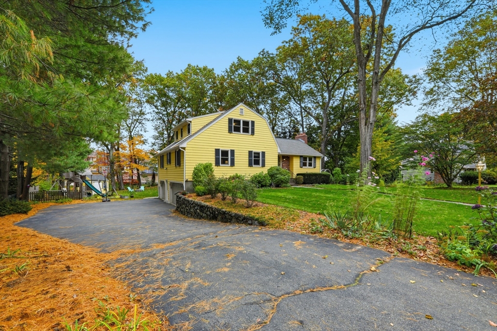 5 Carnegie Place Lexington, MA 02420 - Photo 2 of 39 a front view of a house with a yard and garage
