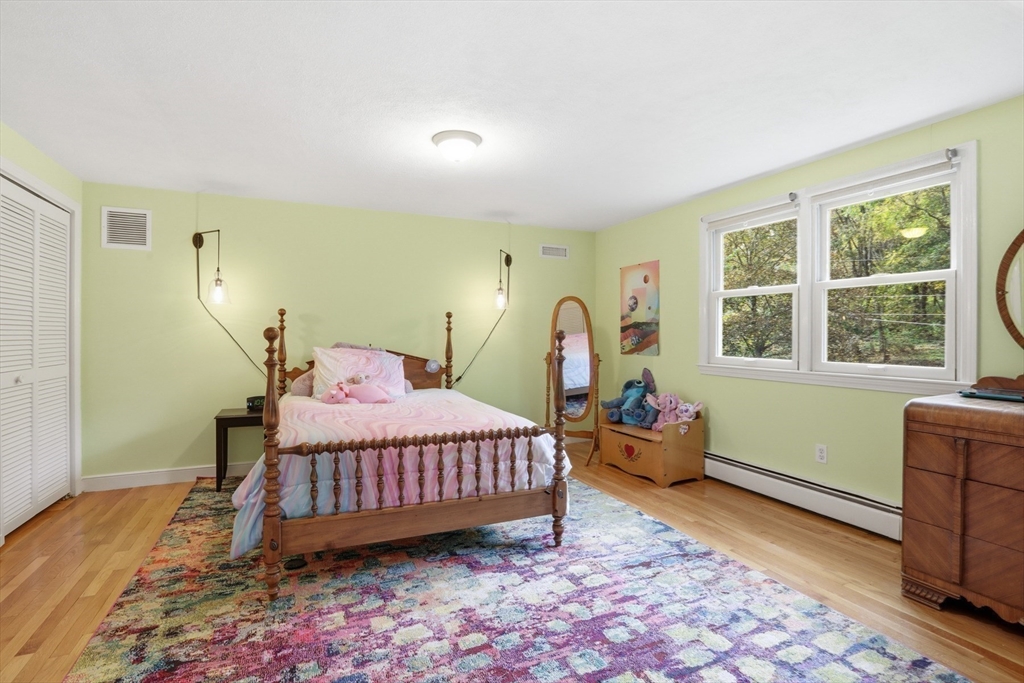 5 Carnegie Place Lexington, MA 02420 - Photo 21 of 39 a bedroom with a bed and wooden floor
