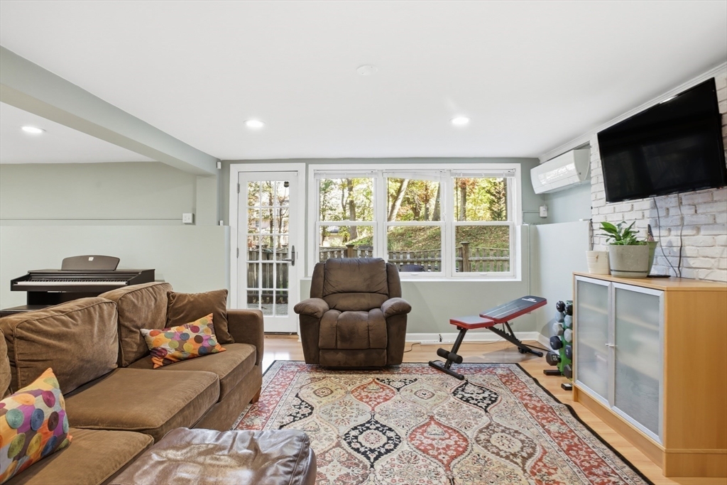 5 Carnegie Place Lexington, MA 02420 - Photo 27 of 39 a living room with furniture and a flat screen tv