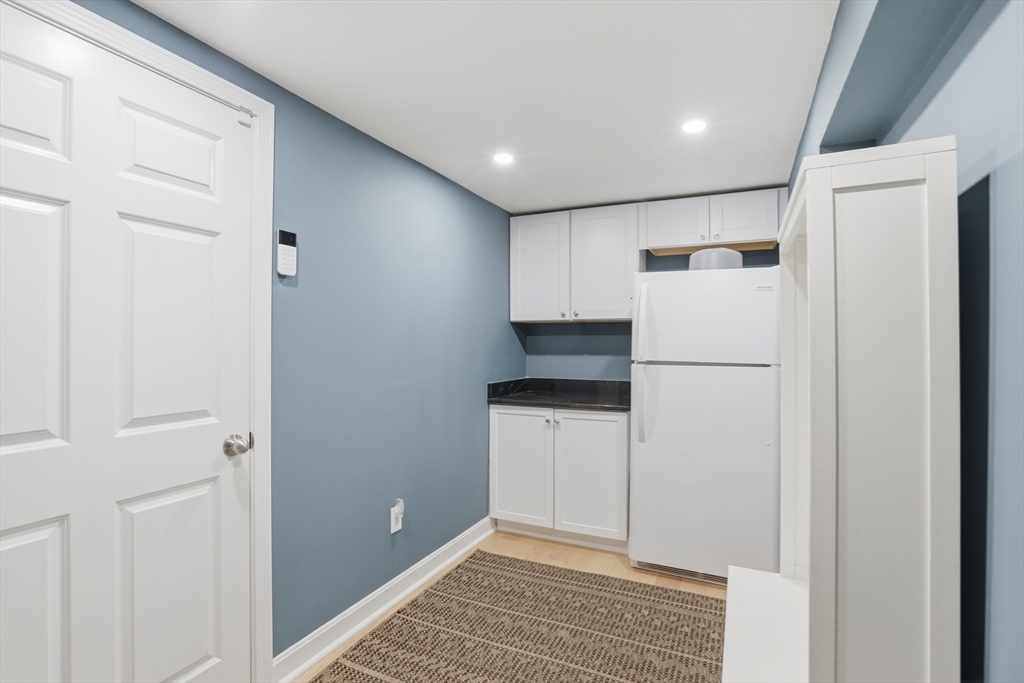 5 Carnegie Place Lexington, MA 02420 - Photo 31 of 39 a view of a kitchen with refrigerator and white wall