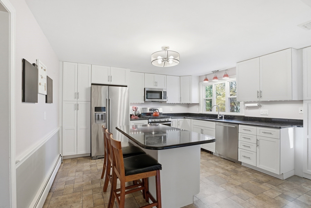 5 Carnegie Place Lexington, MA 02420 - Photo 8 of 39 a kitchen with stainless steel appliances granite countertop a stove refrigerator sink and microwave