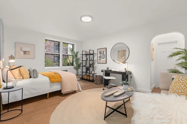 a bedroom with furniture and a mirror