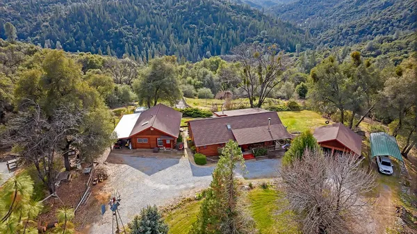 an aerial view of a house with a yard basket ball court and outdoor seating