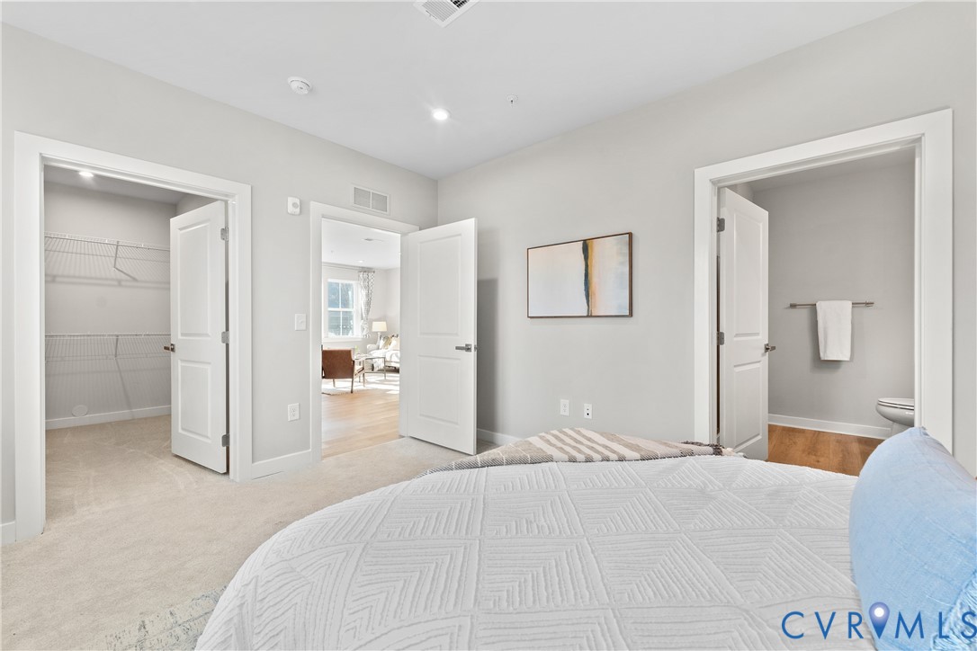 6601 Citory Way, Unit 106 Moseley, VA 23120 - Photo 17 of 39 a bedroom with a bed and a bathroom