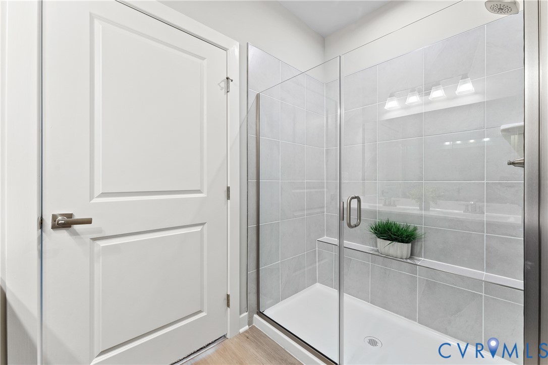 6601 Citory Way, Unit 106 Moseley, VA 23120 - Photo 19 of 39 a bathroom with a shower and a glass door