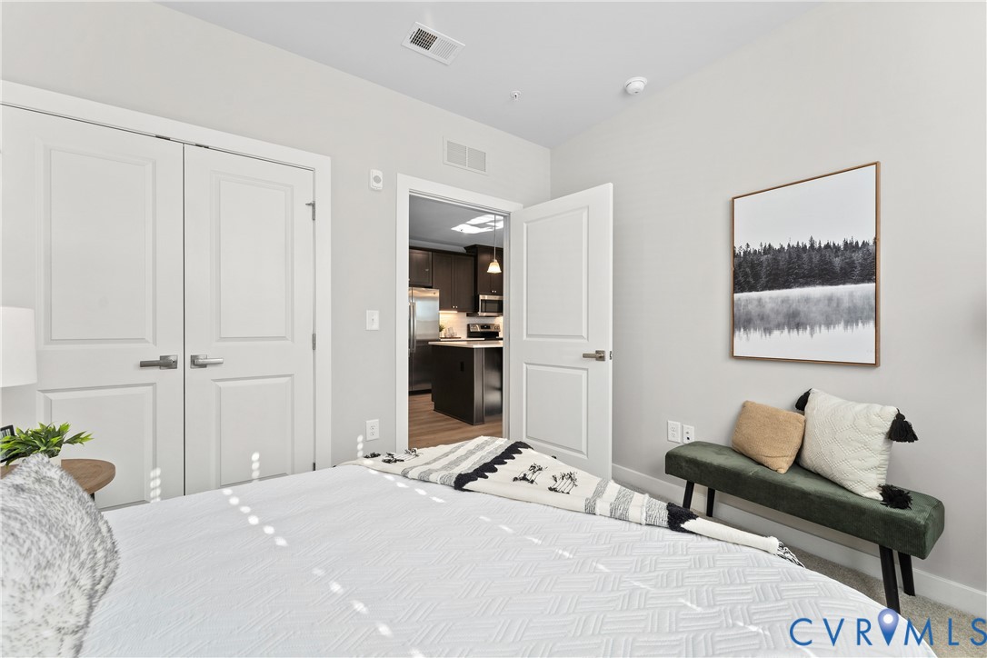 6601 Citory Way, Unit 106 Moseley, VA 23120 - Photo 21 of 39 a bedroom with a bed and furniture