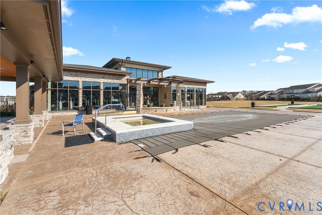 6601 Citory Way, Unit 106 Moseley, VA 23120 - Photo 34 of 39 a view of a building with a swimming pool and sitting area