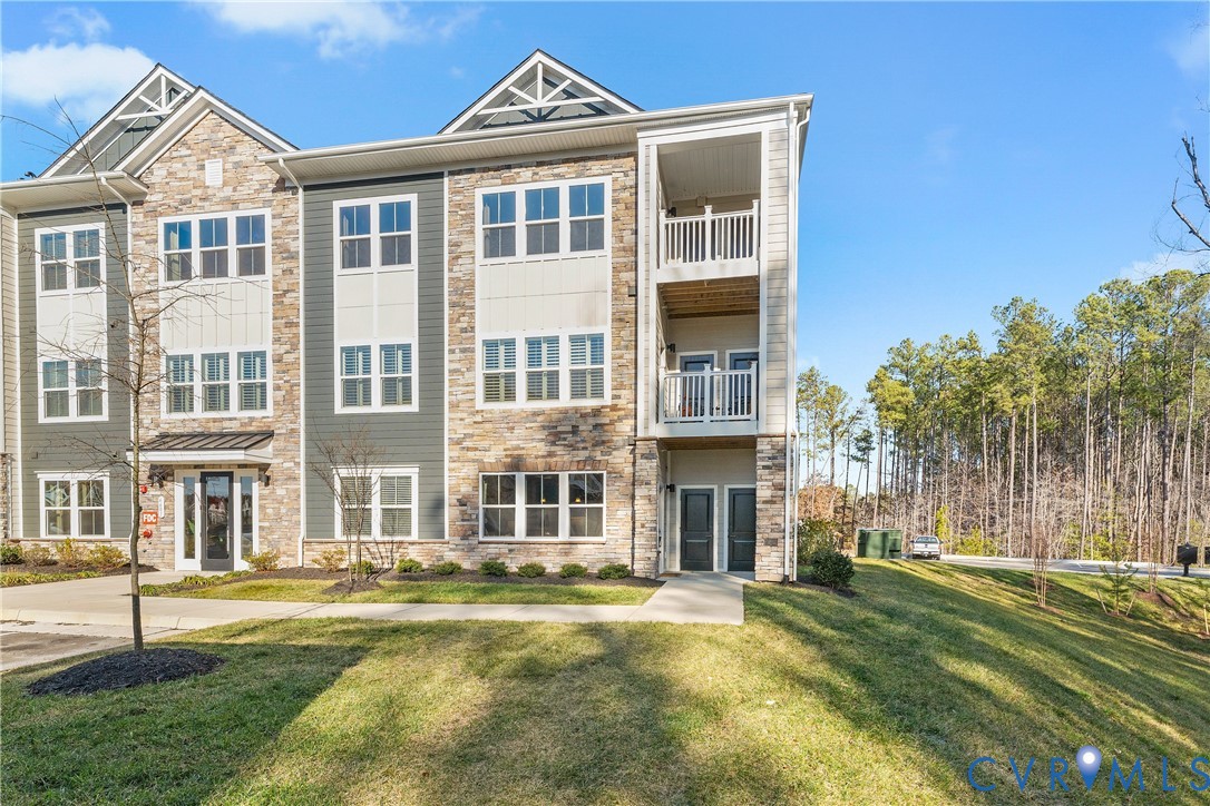 6601 Citory Way, Unit 106 Moseley, VA 23120 - Photo 38 of 39 a front view of a residential apartment building with a yard