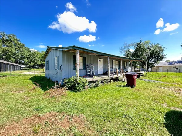 a view of a house with backyard porch and sitting area