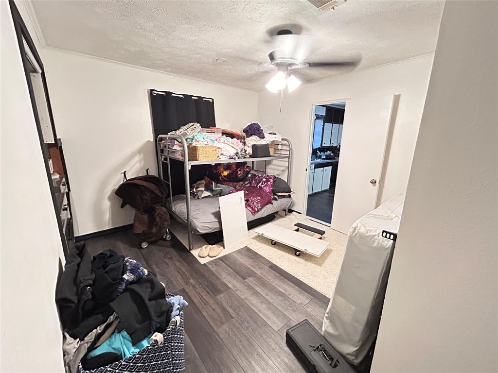 104 Gaskins Street Como, TX 75431 - Photo 12 of 15 a workspace with furniture and wooden floor