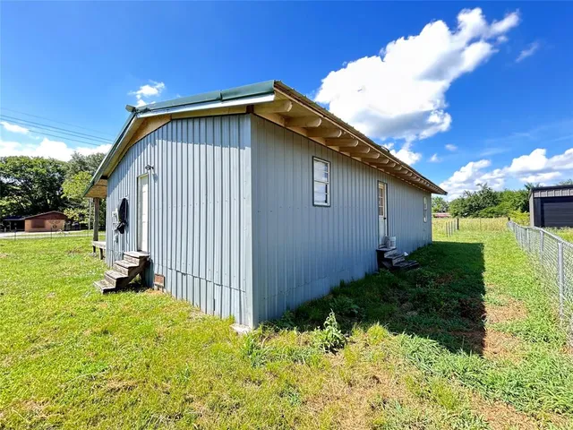 a view of a house with backyard porch and sitting area