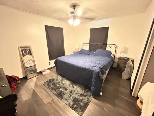 a living room with furniture a flat screen tv and a window