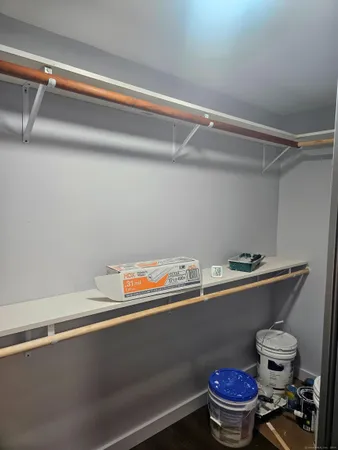 a room with a wooden floor and cabinets