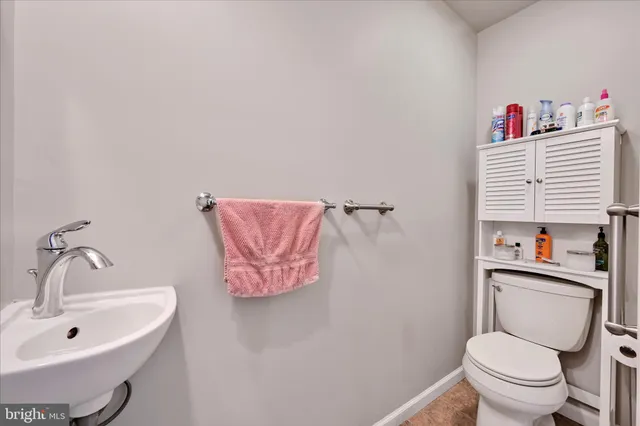 a bathroom with a toilet sink and vanity