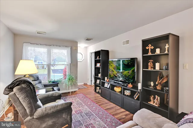 a living room with furniture and a lamp