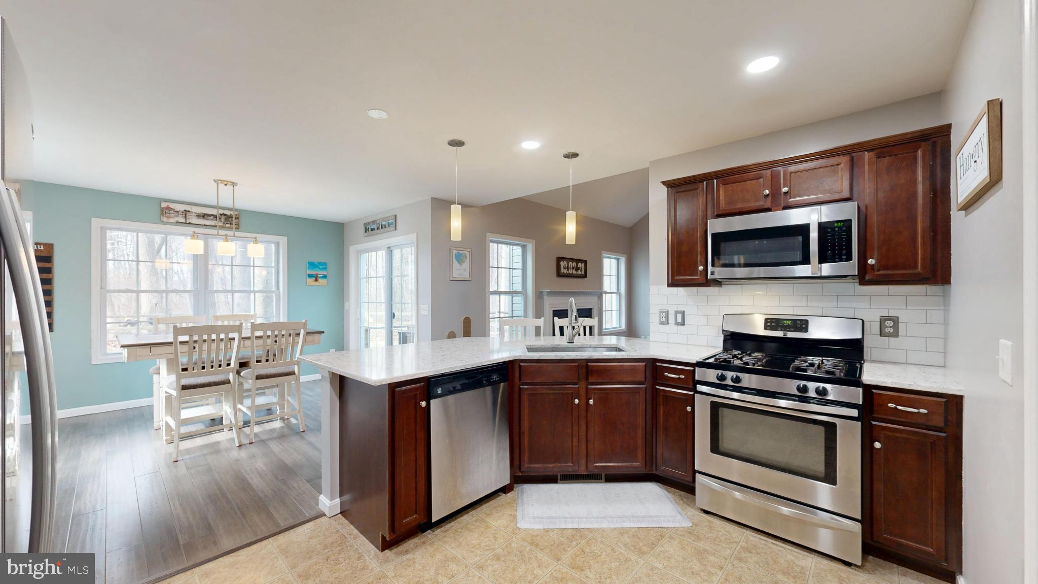 202 East Buck Point Road Clayton, DE 19938 - Photo 12 of 53 a kitchen with a sink stove and microwave