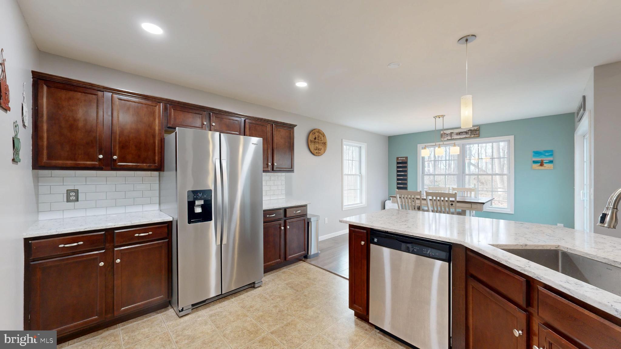 202 East Buck Point Road Clayton, DE 19938 - Photo 13 of 53 a kitchen with stainless steel appliances a sink stove and refrigerator