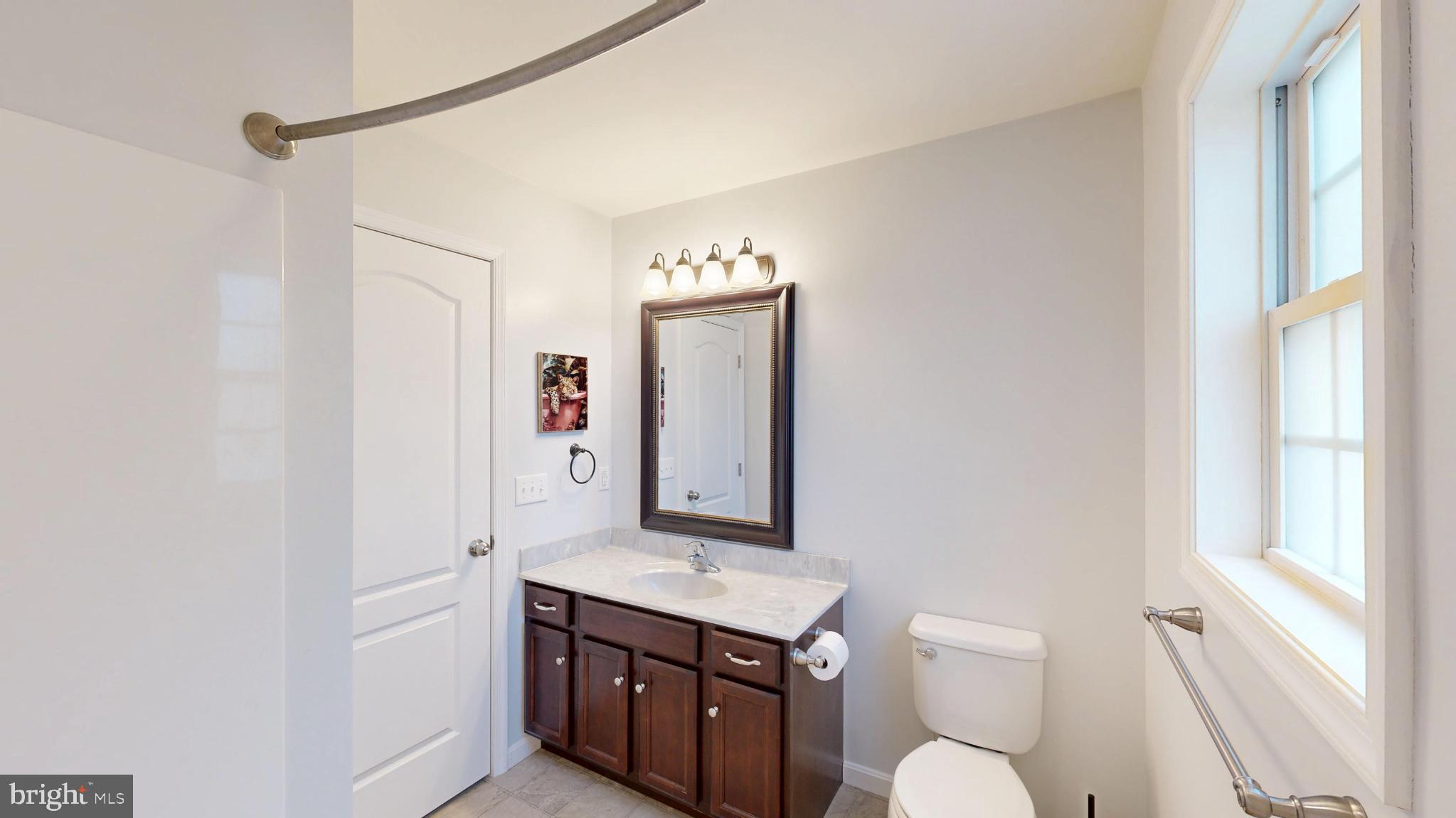 202 East Buck Point Road Clayton, DE 19938 - Photo 24 of 53 a bathroom with a toilet a sink and a mirror