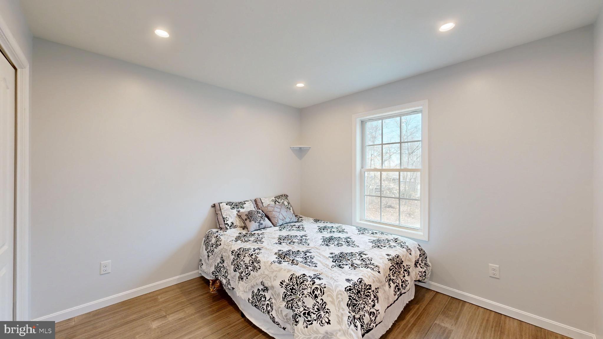 202 East Buck Point Road Clayton, DE 19938 - Photo 25 of 53 a bedroom with a bed and a window