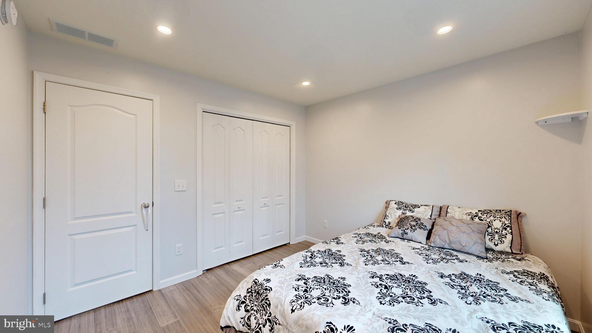202 East Buck Point Road Clayton, DE 19938 - Photo 26 of 53 a bedroom with a large bed and wooden floor