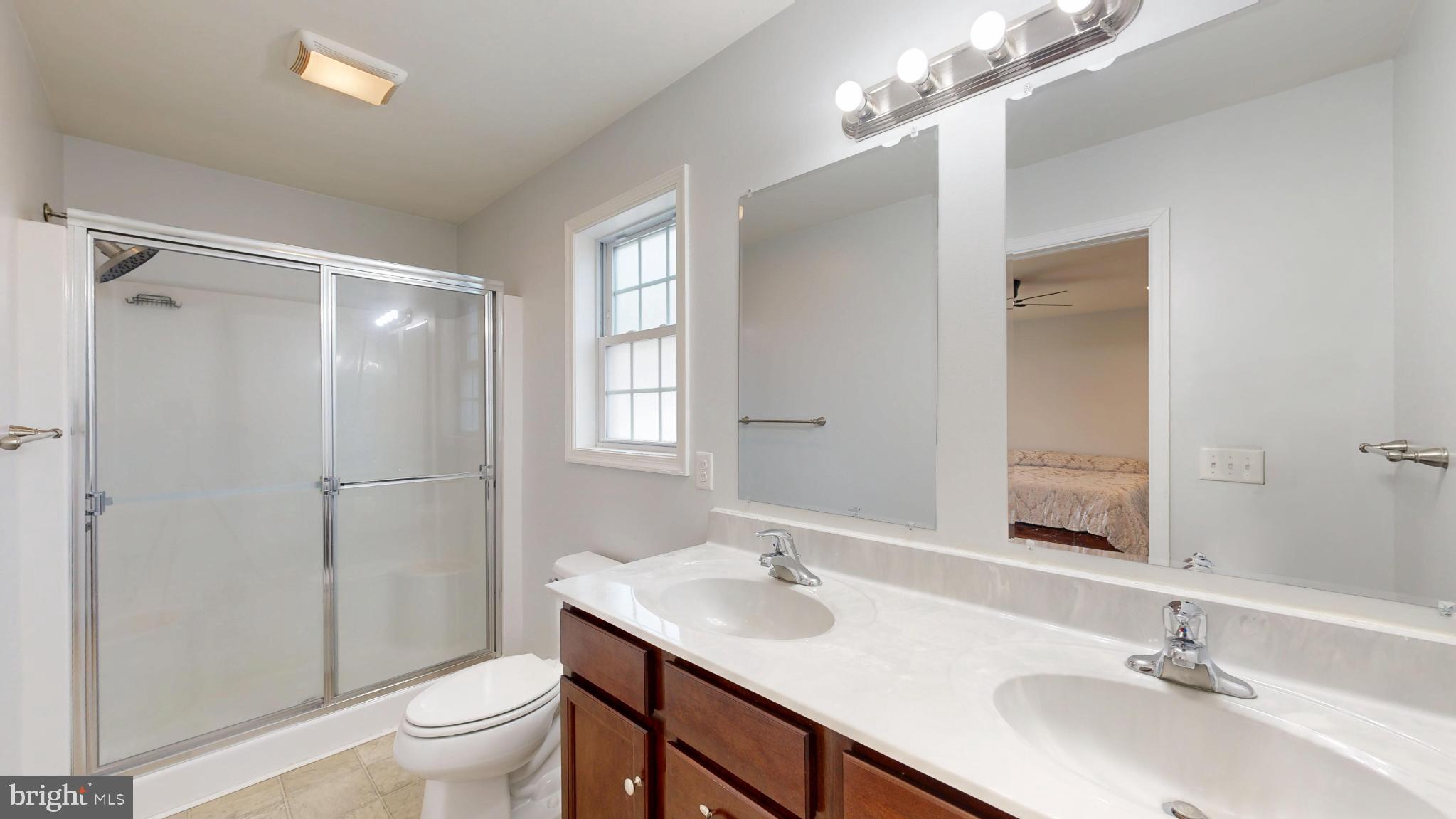 202 East Buck Point Road Clayton, DE 19938 - Photo 28 of 53 a bathroom with a sink toilet a mirror and shower