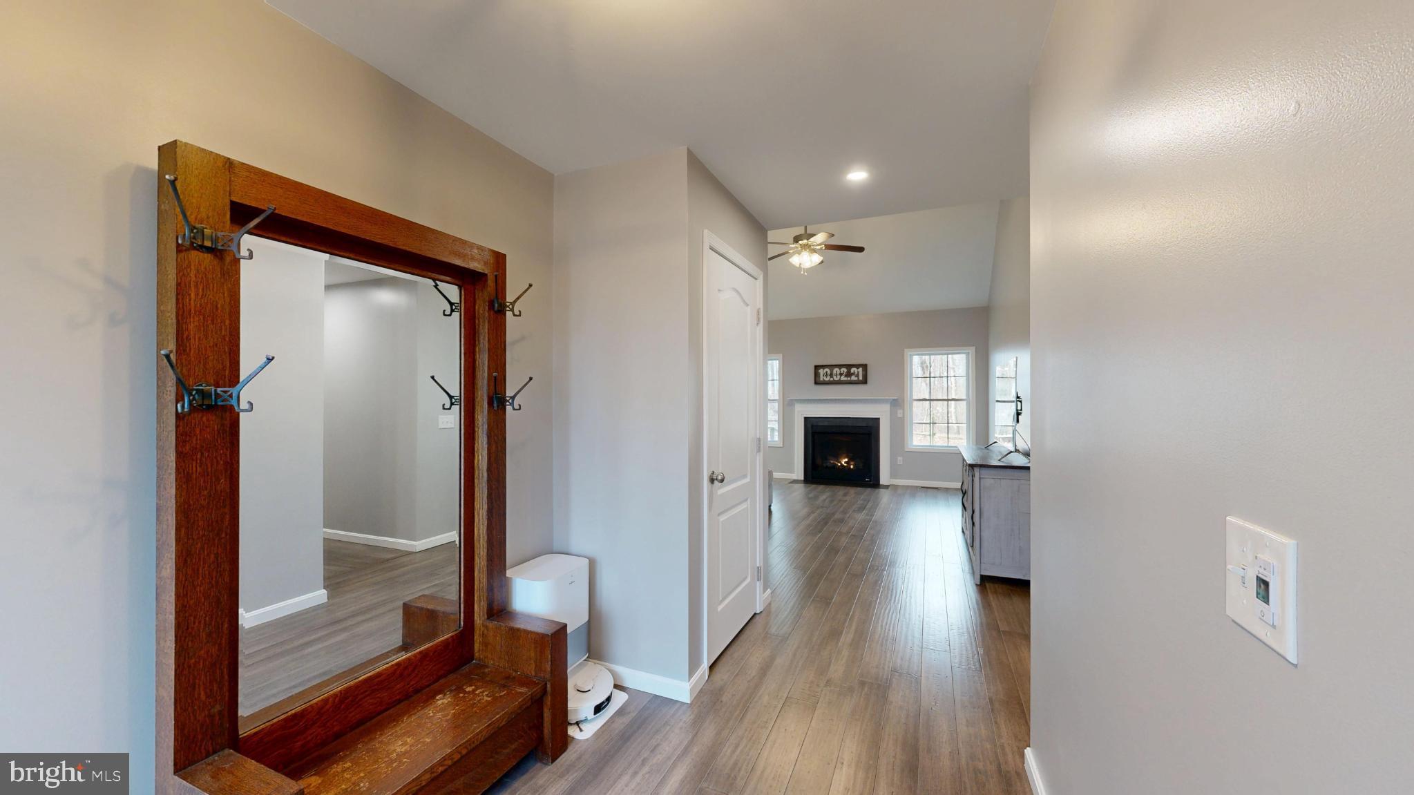 202 East Buck Point Road Clayton, DE 19938 - Photo 3 of 53 a view of a hallway view with wooden floor and staircase