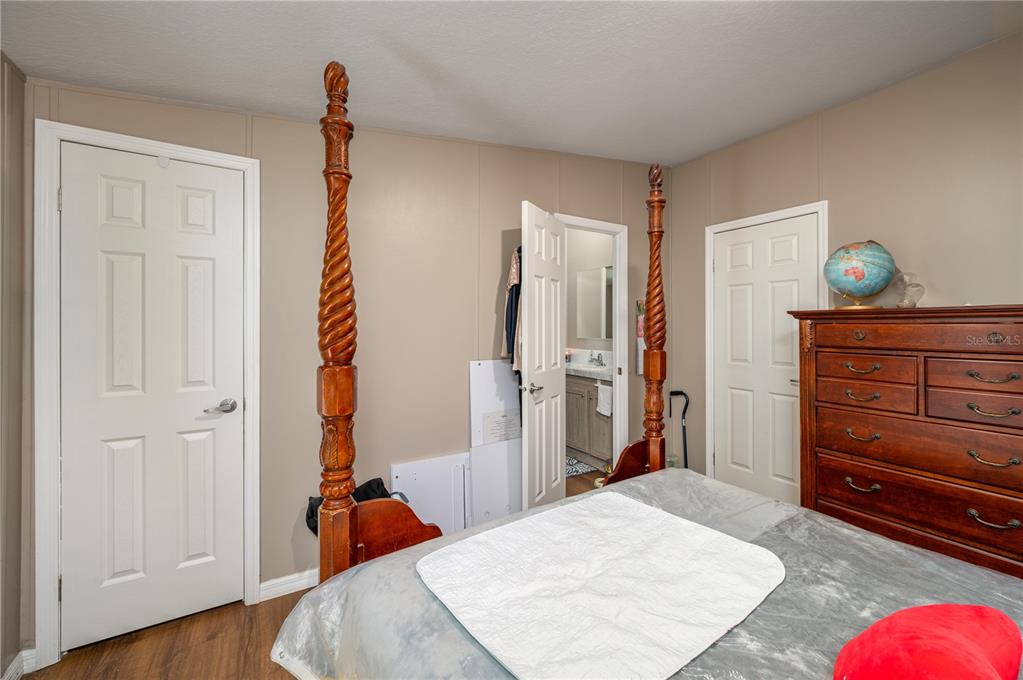 15079 Brahma Road Polk City, FL 33868 - Photo 33 of 40 a bed room with a bed and a dresser