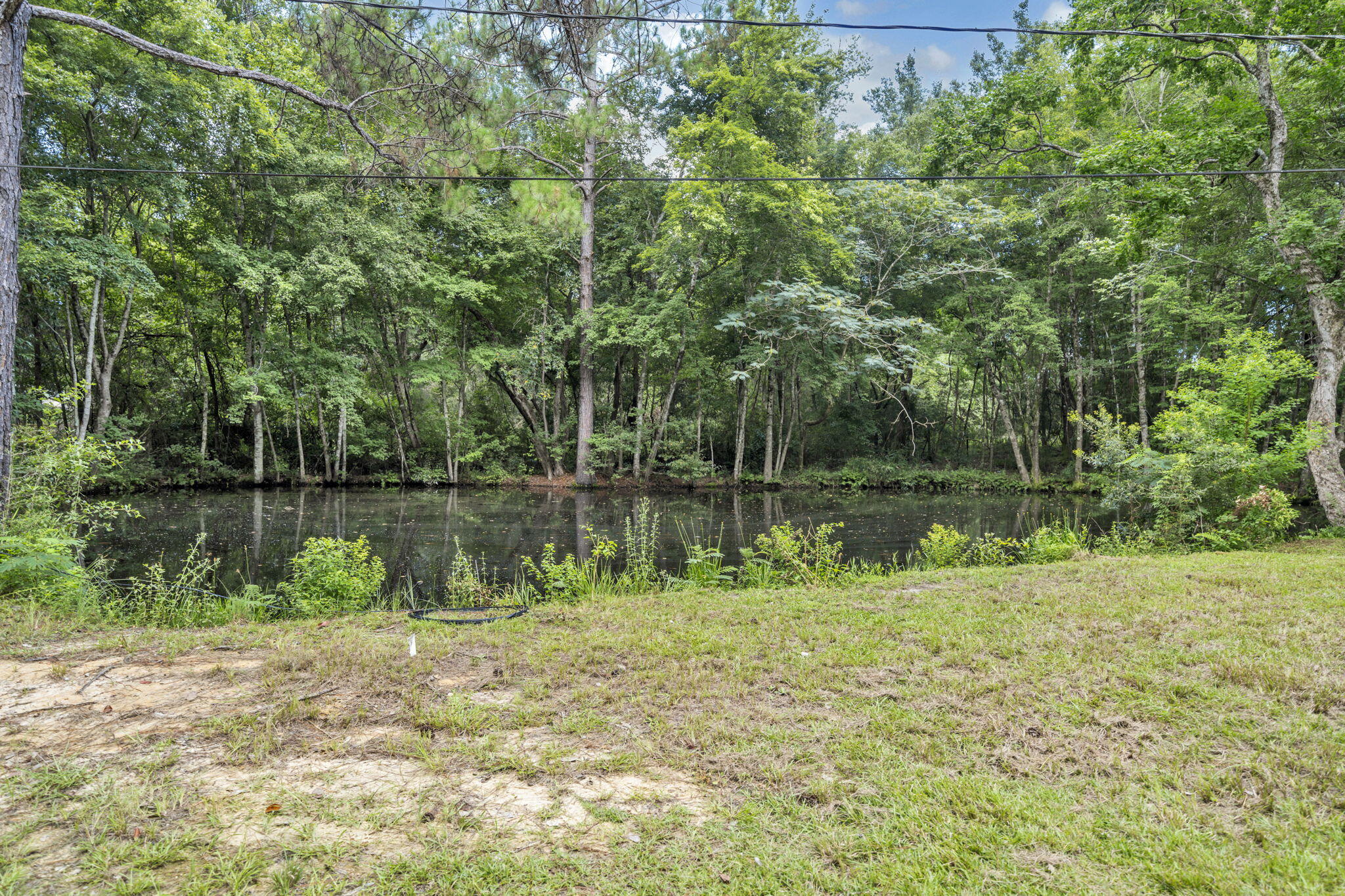 6359 Childrens Lane Crestview, FL 32539 - Photo 11 of 50 a backyard of a house with lots of green space