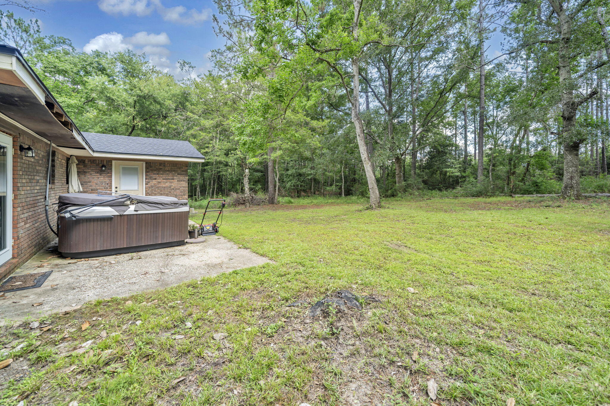6359 Childrens Lane Crestview, FL 32539 - Photo 12 of 50 a backyard of a house with table and chairs