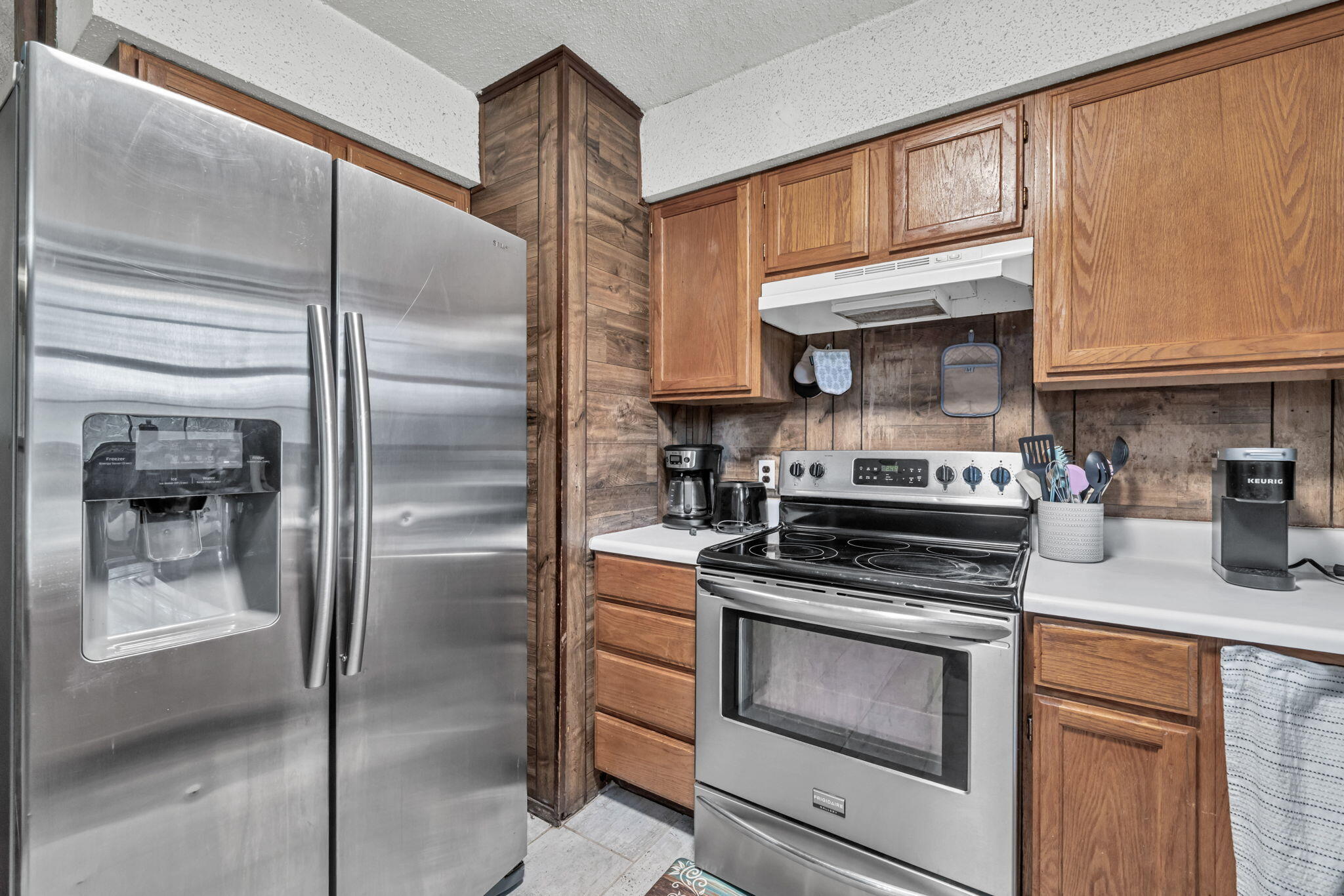 6359 Childrens Lane Crestview, FL 32539 - Photo 18 of 50 a kitchen with stainless steel appliances granite countertop a refrigerator a stove and a sink with cabinets