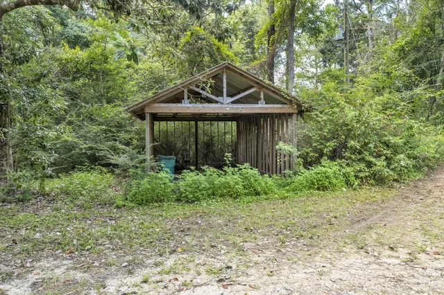 a backyard of a house with lots of green space and fountain