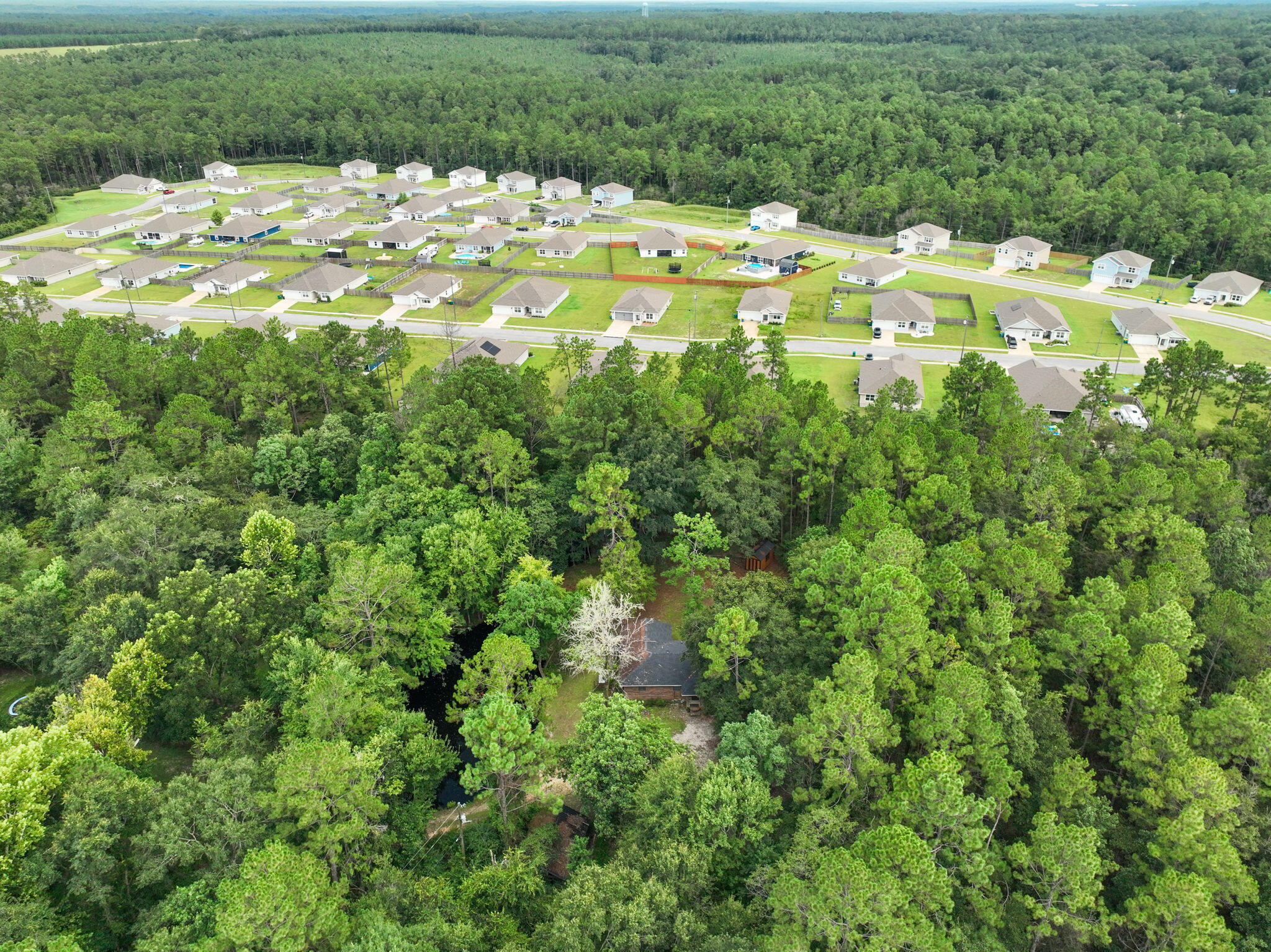 6359 Childrens Lane Crestview, FL 32539 - Photo 41 of 50 a view of a lake with a house