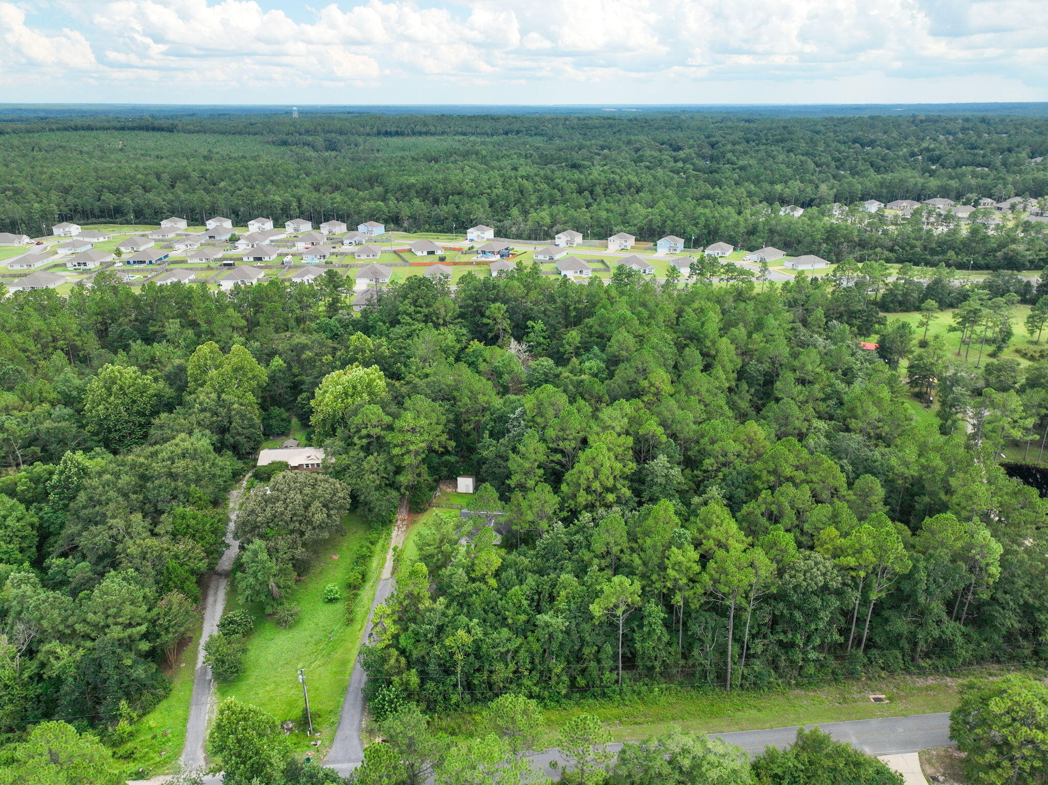 6359 Childrens Lane Crestview, FL 32539 - Photo 44 of 50 an aerial view of residential houses with outdoor space and trees
