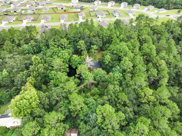 an aerial view of residential houses with outdoor space