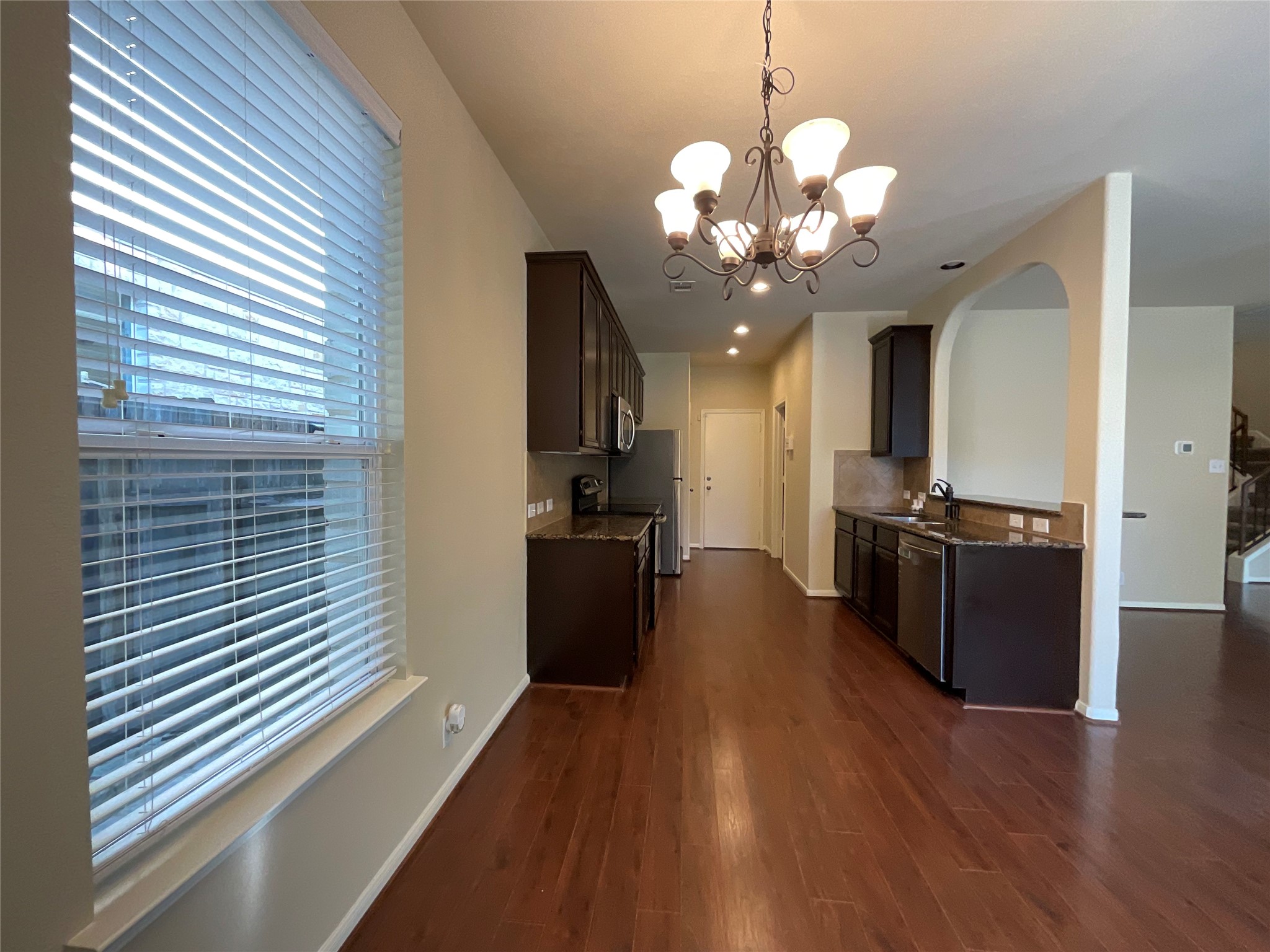 1911 Conn Creek Road Cedar Park, TX 78613 - Photo 15 of 39 a view of a kitchen with a sink wooden floor and a kitchen