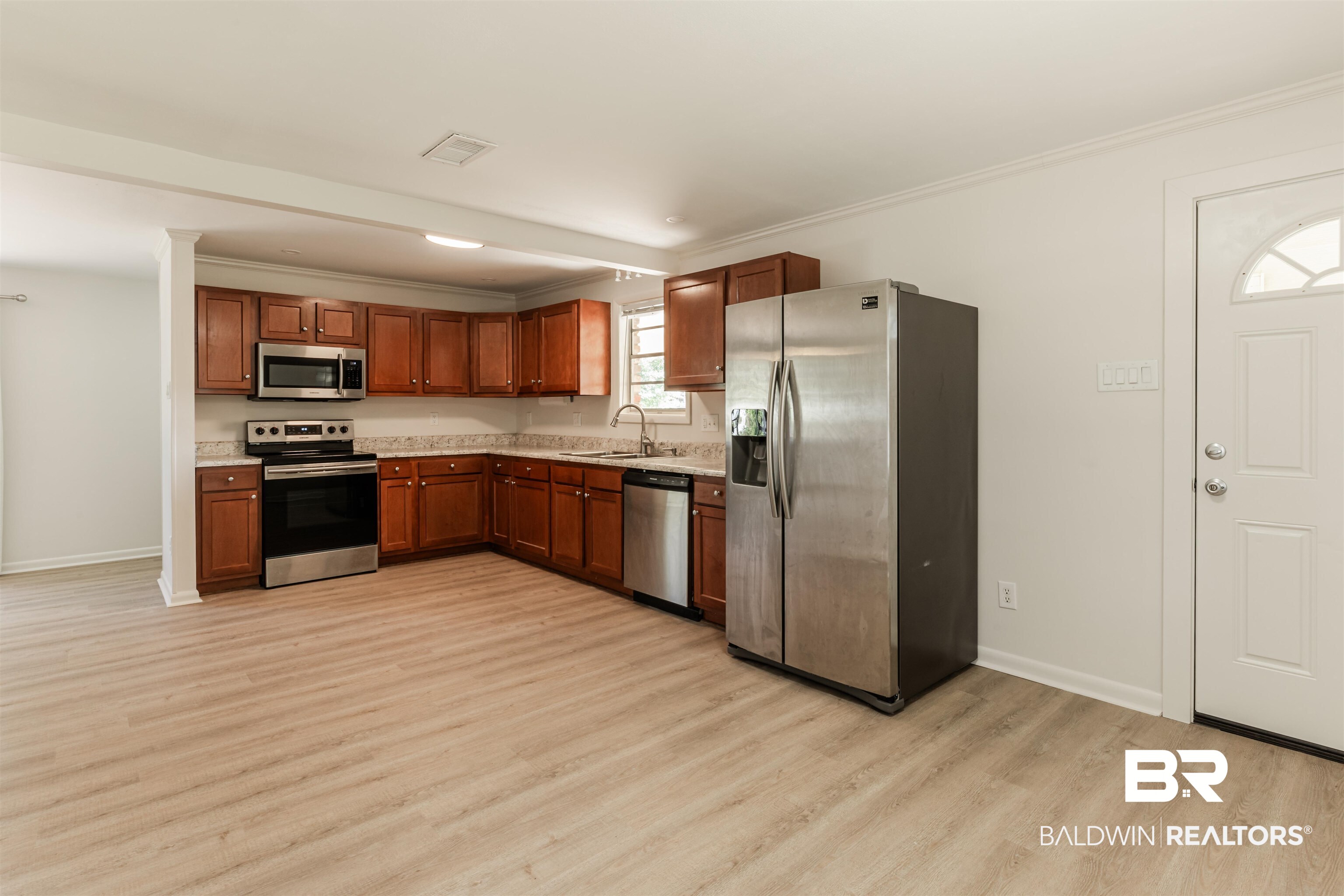 3970 Oak Ridge Avenue Mobile, AL 36619 - Photo 7 of 28 Kitchen with light hardwood / wood-style flooring, stainless steel appliances, sink, and crown molding