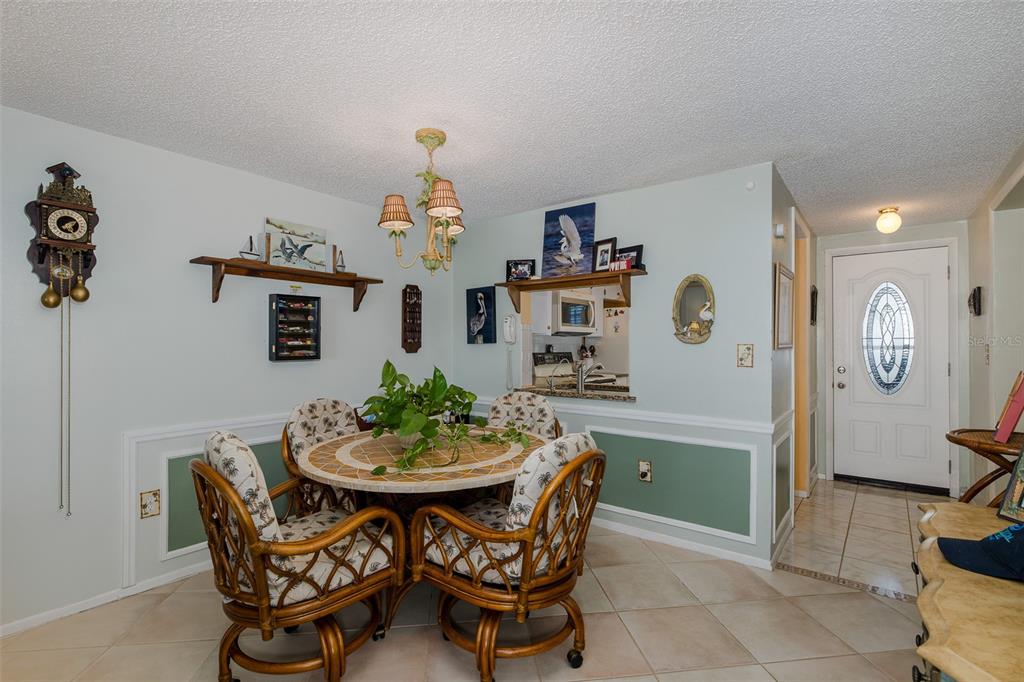 4206 Richmere Drive, Unit 3 New Port Richey, FL 34652 - Photo 18 of 41 a dining room with furniture and window